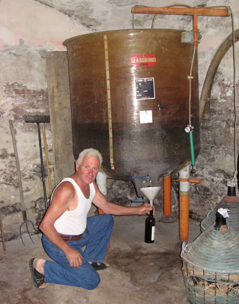 A Piedmont Italy farmer showing his wine fermentation tank