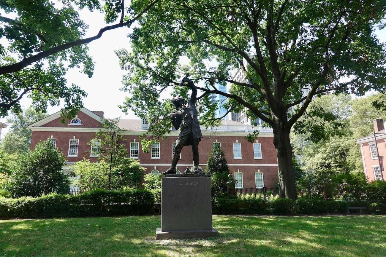 The signer statue commemorating the men who signed the Declaration of Independence sits in this small pocket park in Philadelphia.