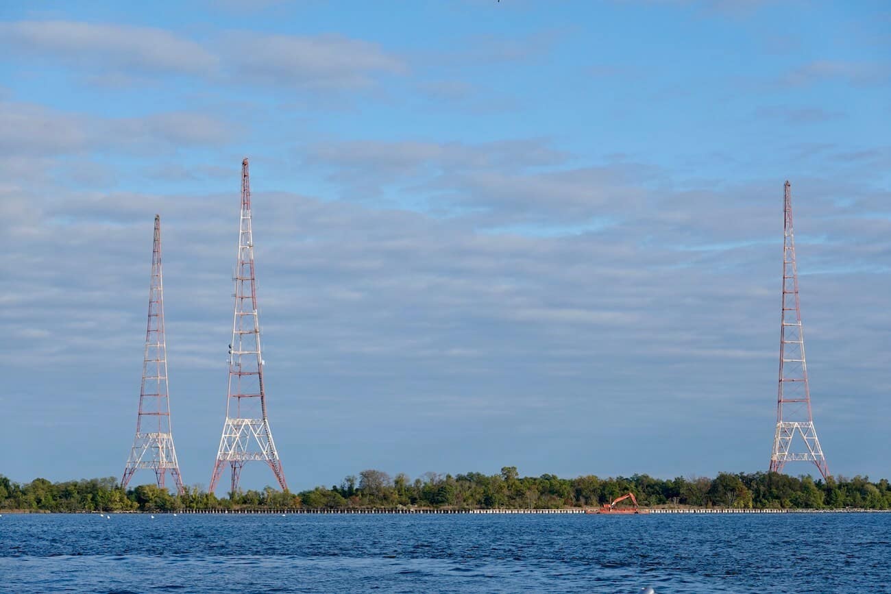 Three radio towers stand near the shore in Annapolis.