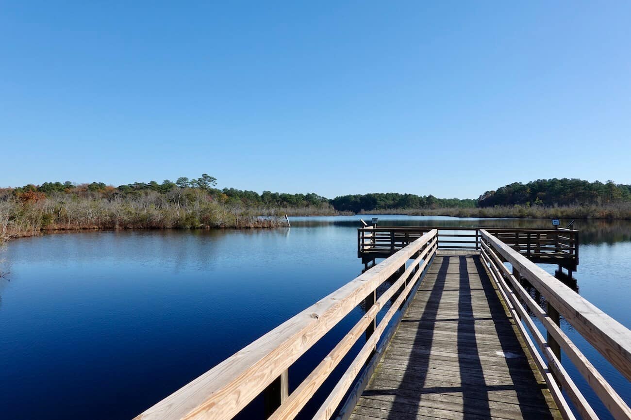 A wooden walkway leads to a deck at Fleetwood Pond at Prime Hook in DE