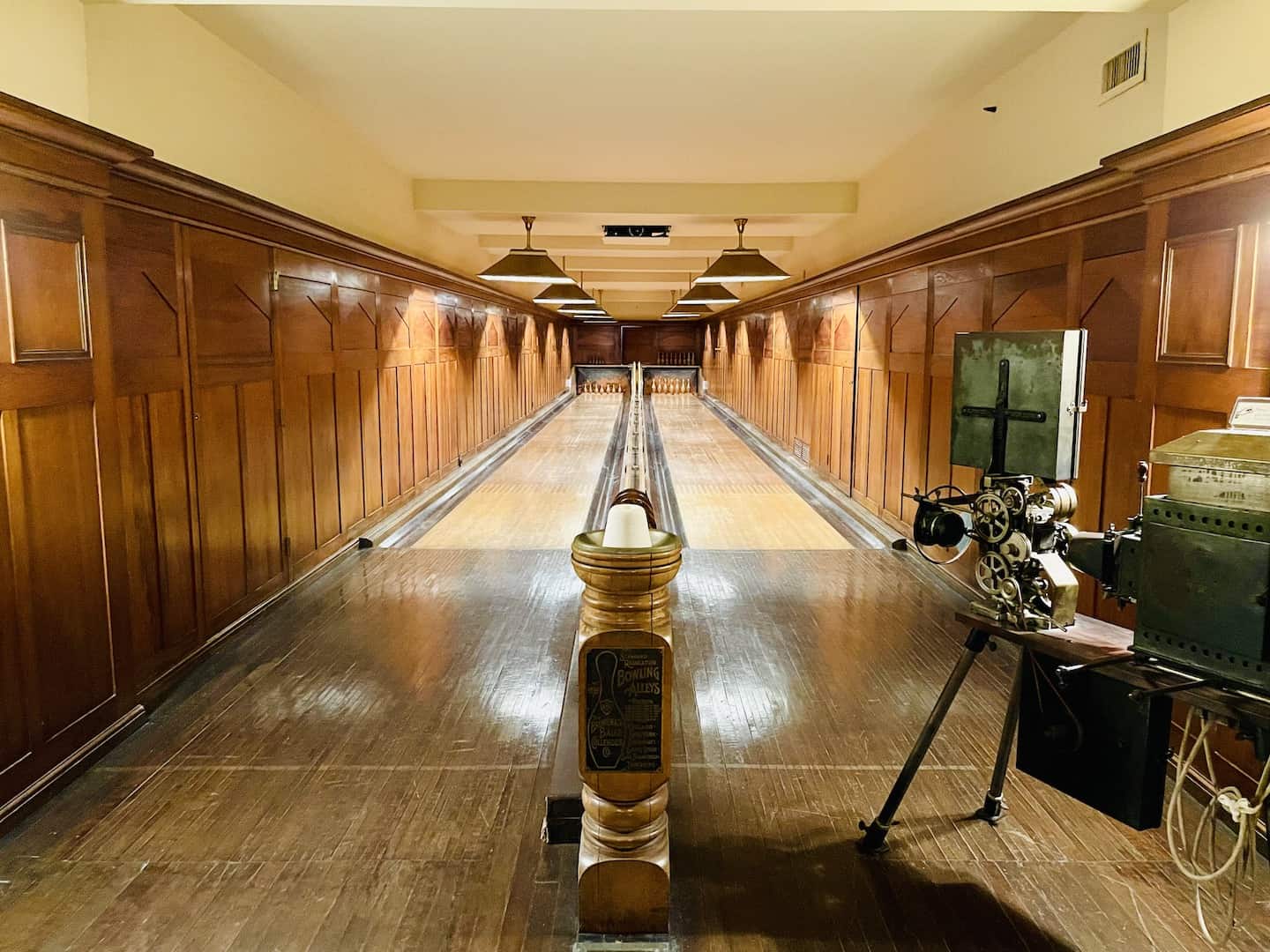 An antique movie came sits near a wooden bowling alley with two lanes at Nemours Estate.