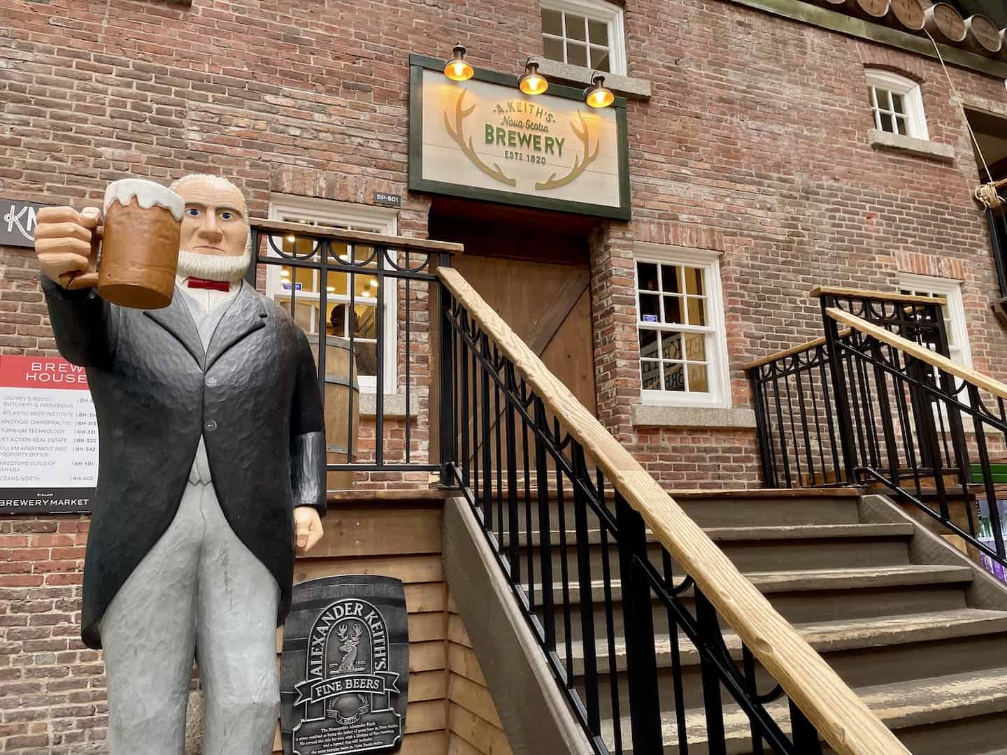 A wooden mannequin holding a mug of beer stands outside the Alexander Keith Brewery in Halifax.