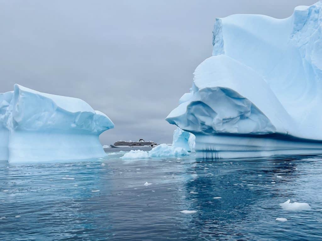 A Viking expedition ship is seen through two icebergs in Antarctica.