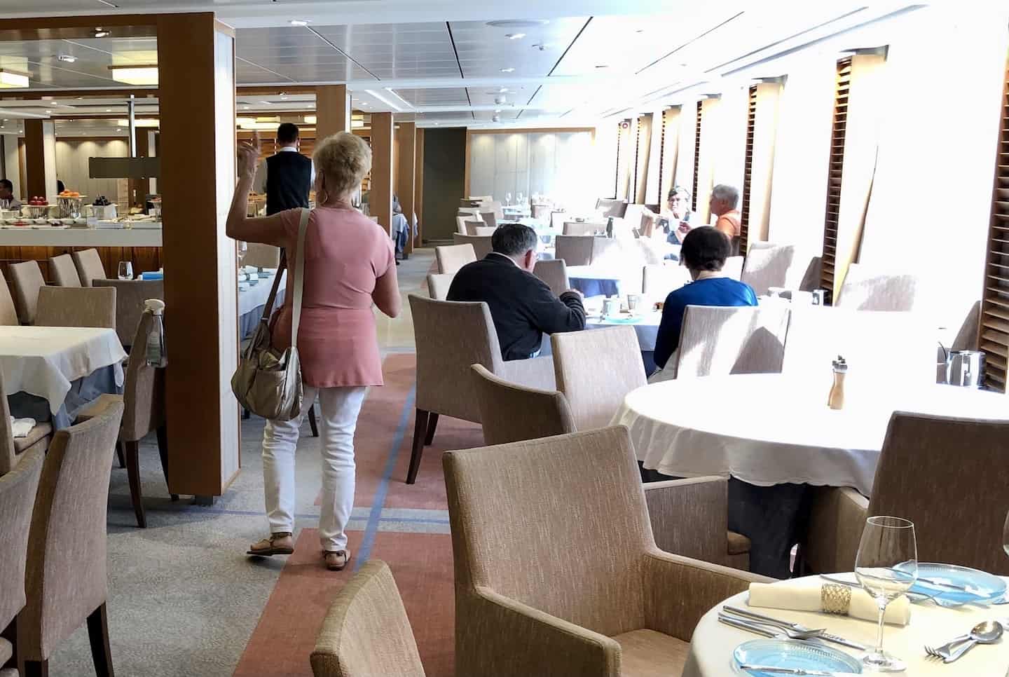 Diners are finishing their meals in the restaurant aboard a Viking river cruise.
