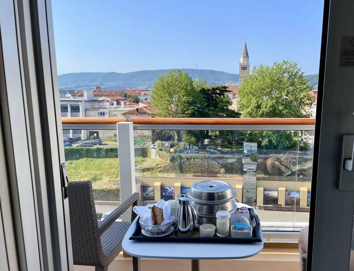 Room service breakfast sits on a small table on the balcony of a Viking Ocean Cruise stateroom.