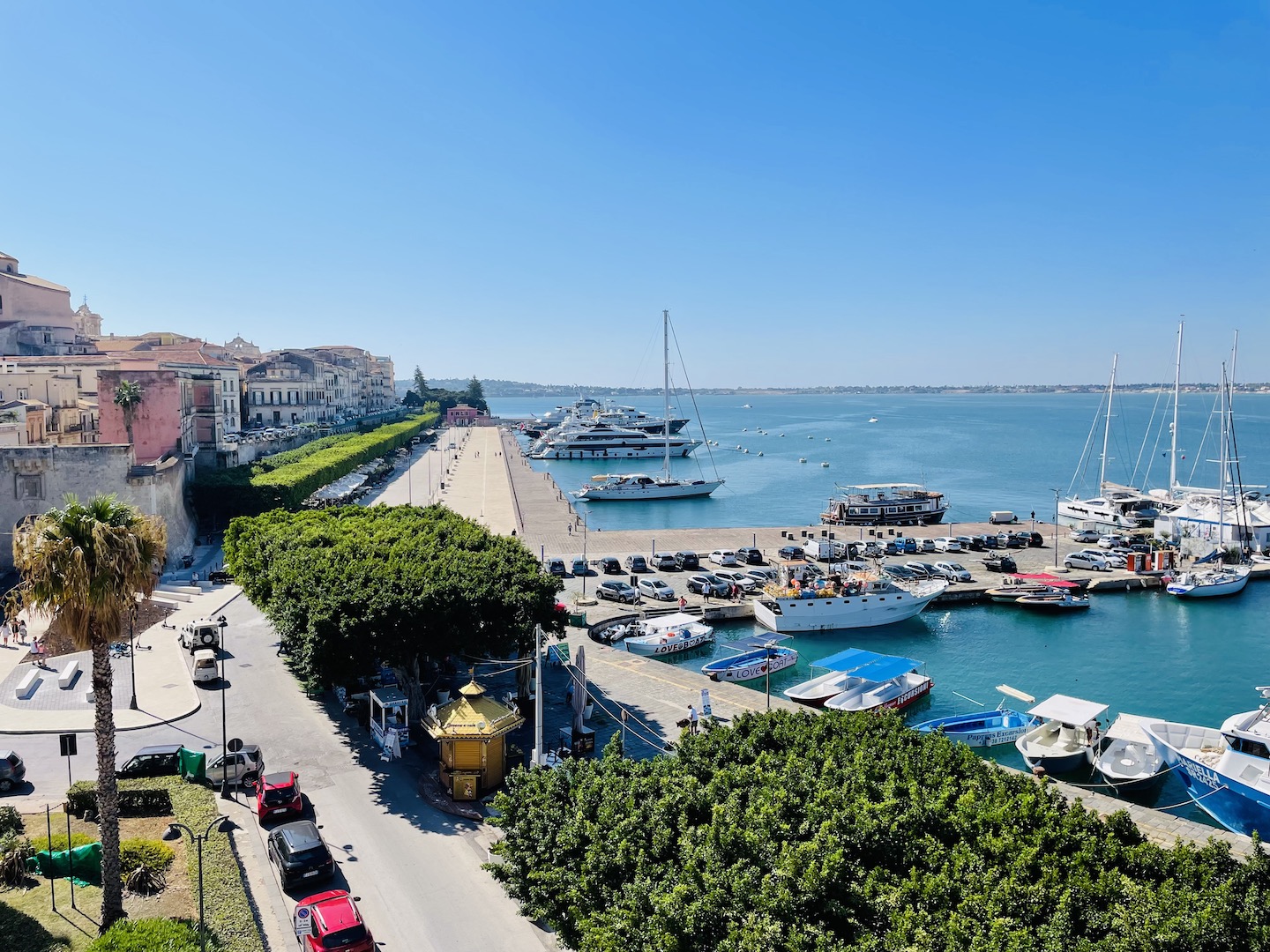 An expansive view of the seaside promenade and marina in Ortigia, Sicily.