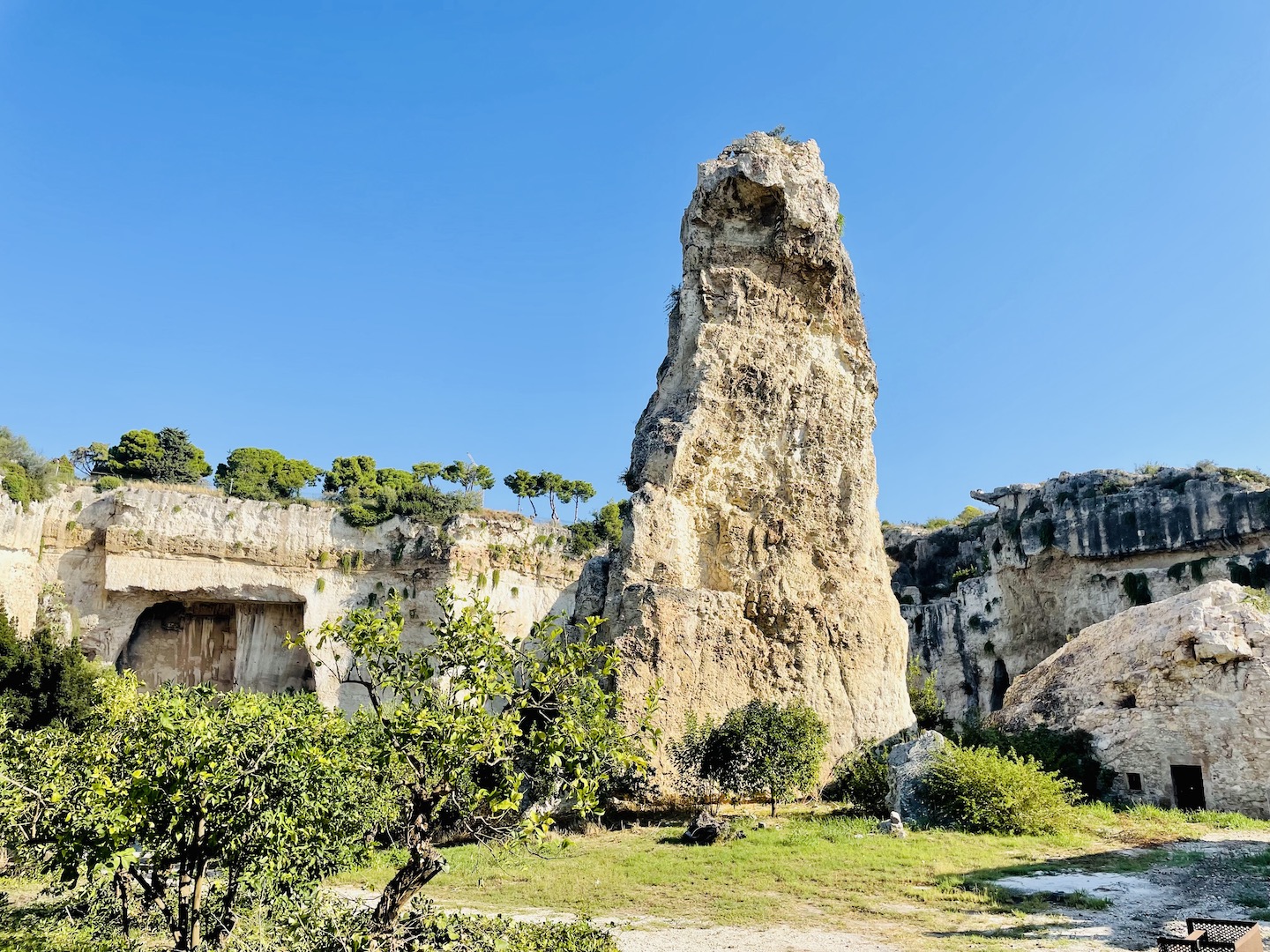 A large column of limestone rock stands at the Neapolis Archaeological Park in Sicily, Italy as a testament to those who suffered here.